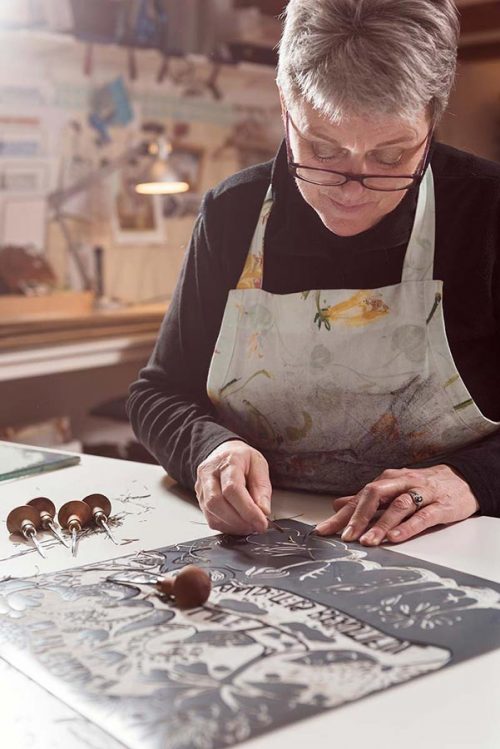 Portrait of an artist working on a linocut.