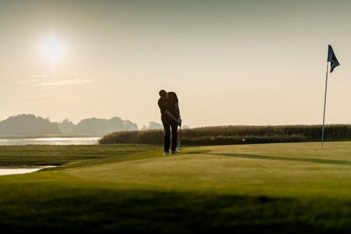 Golfer pitching his shot on to the green