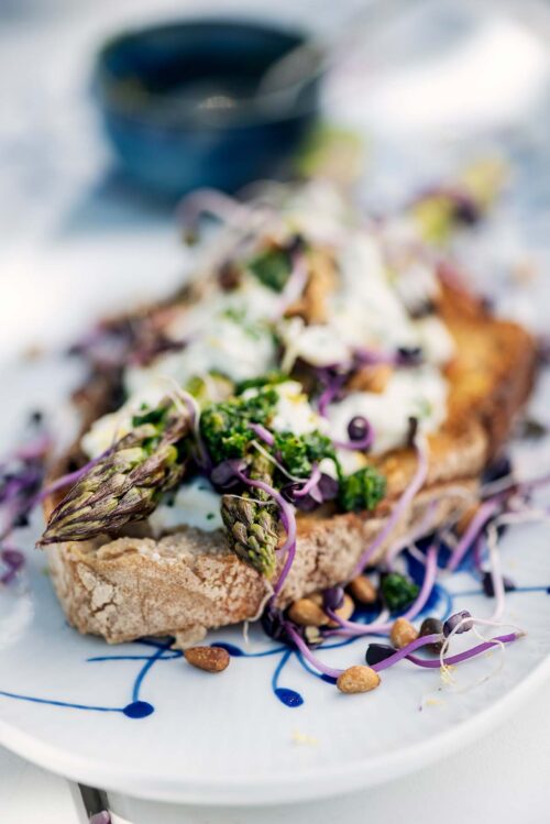 Green asparagus with a lemon gremolata and radish seedlings on crusty bread.