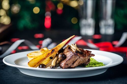 Close-up Dish of beef tenderloin cooked in a sous vide with mushrooms and parsley root vegetables and a potato rosti.